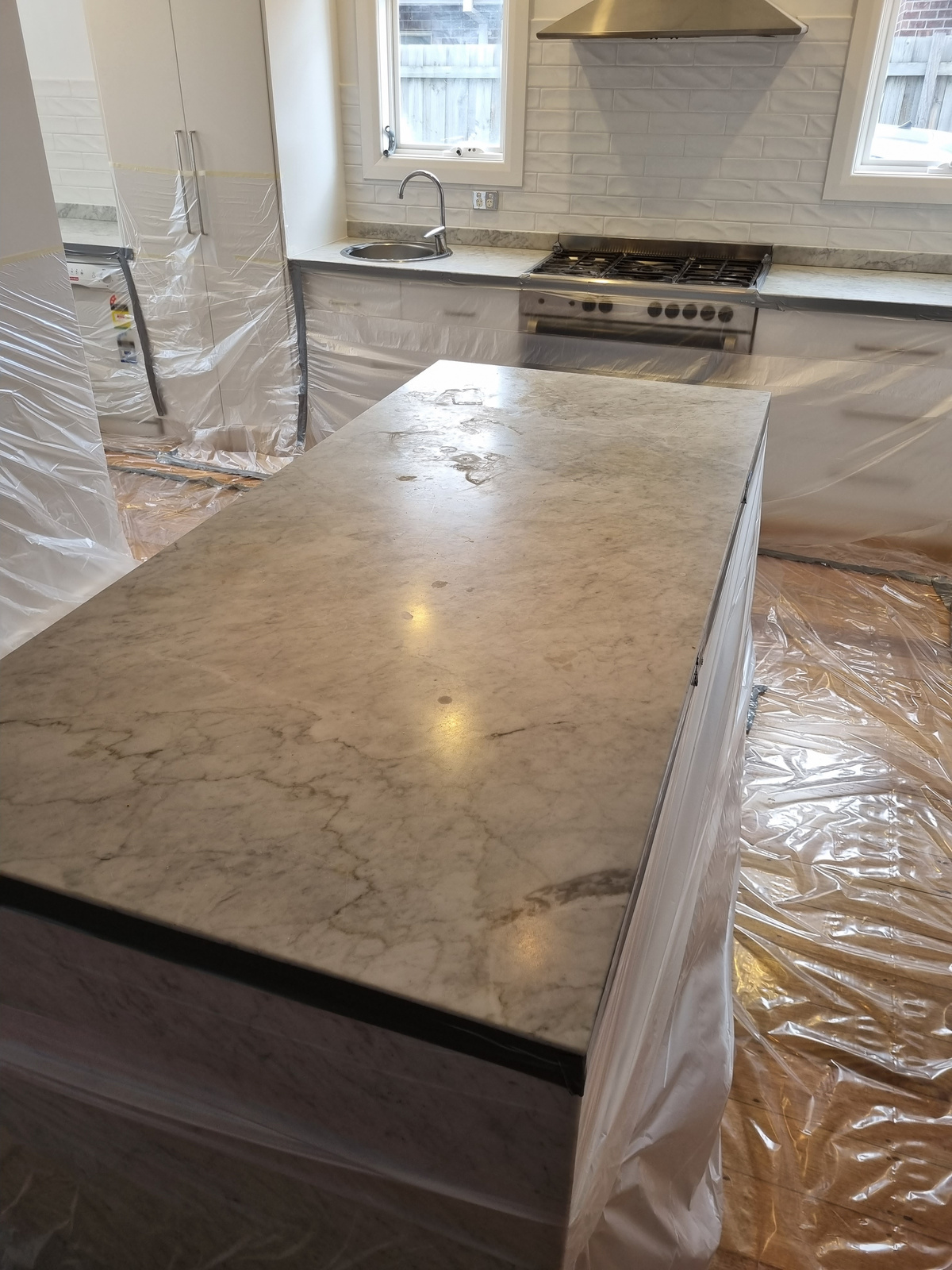 Before — Carrara marble kitchen island dull