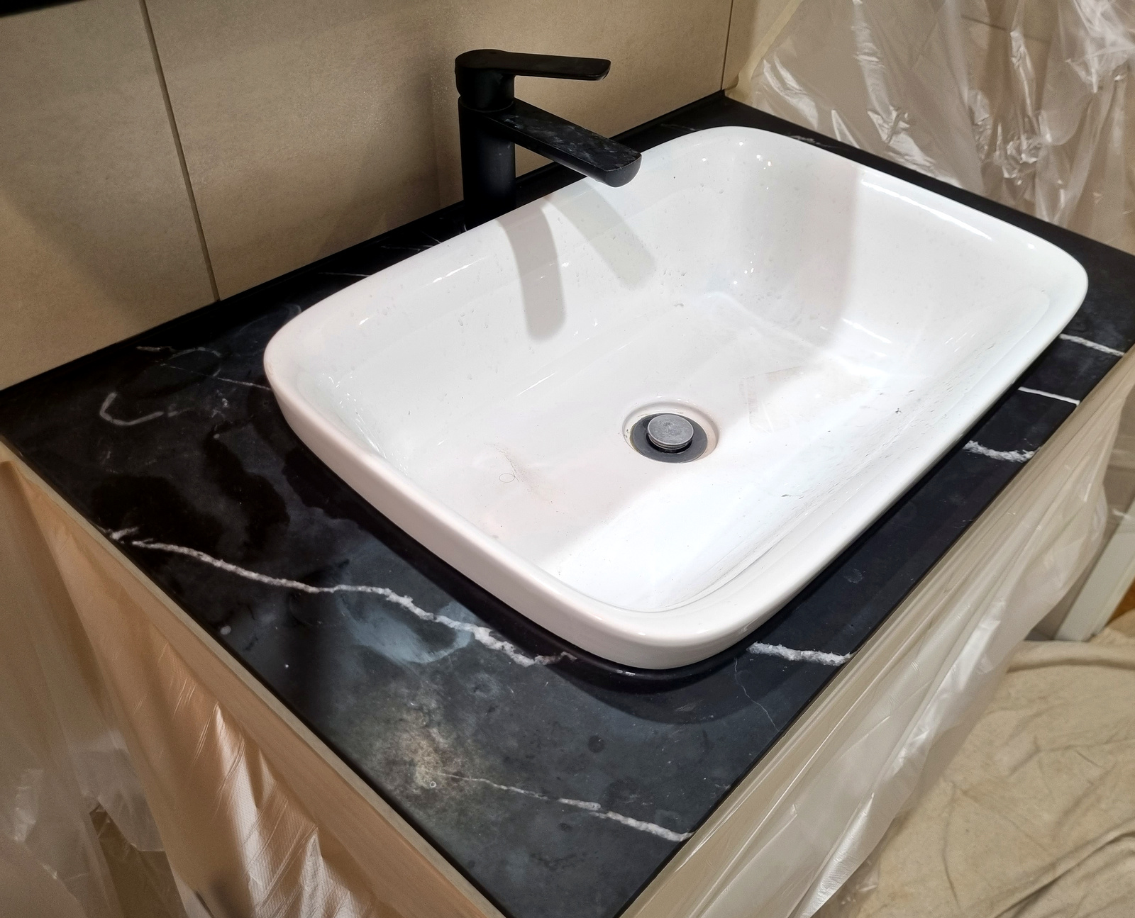 Before — black marble vanity dull